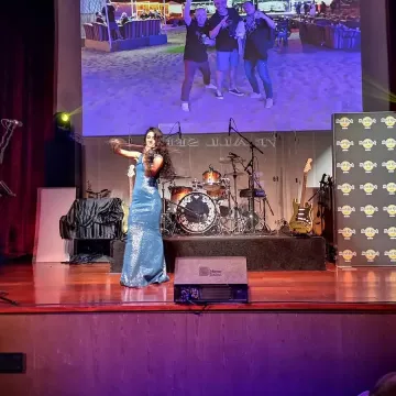Anna Petrasian on stage performing in blue dress